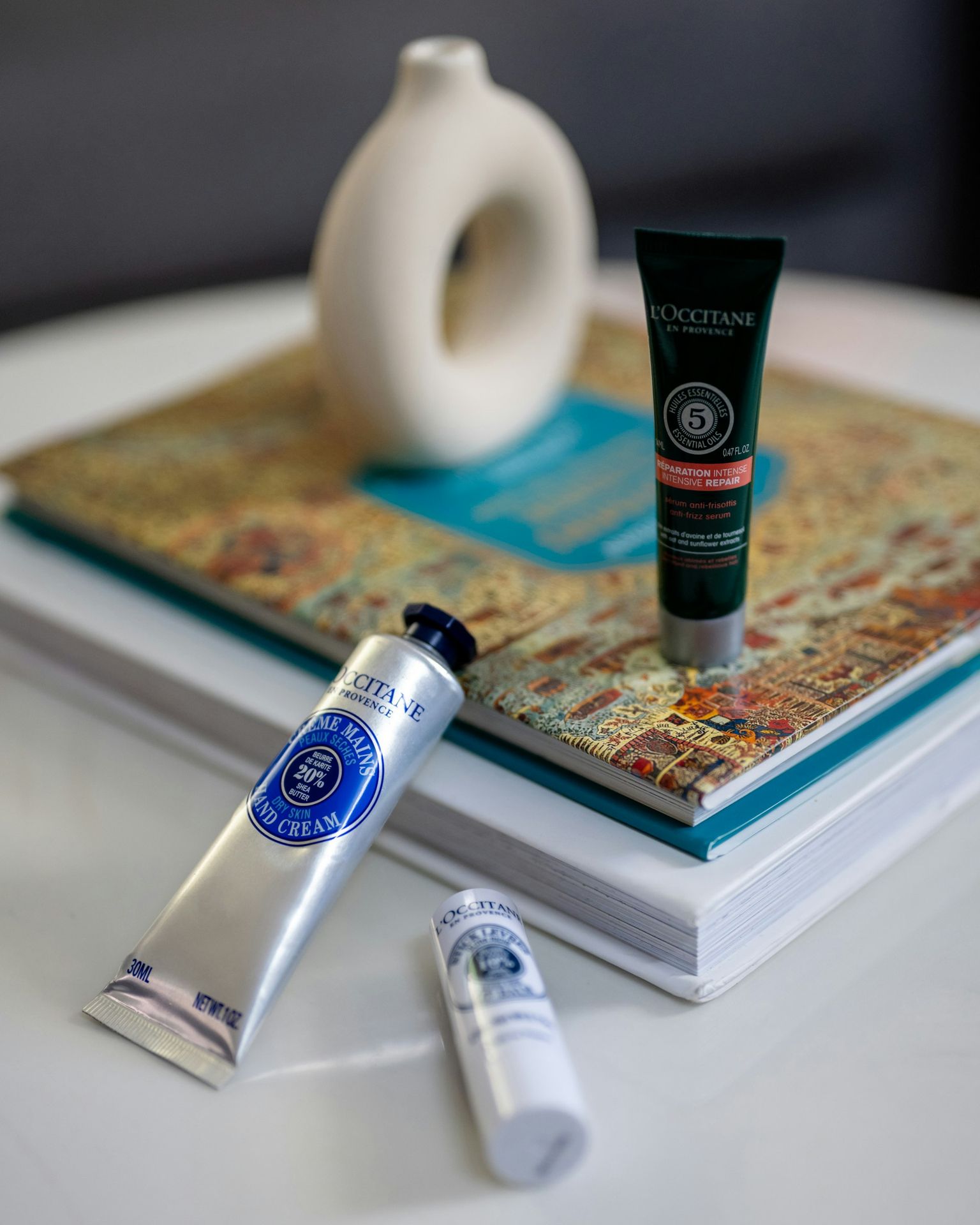 a table topped with a book and a tube of toothpaste